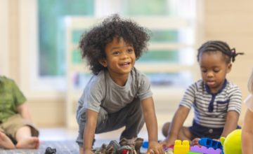 Toddler at child care with toys